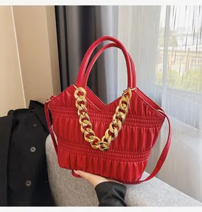 Red quilted handbag for women, stylish top-handle shoulder bag with chunky gold chain.