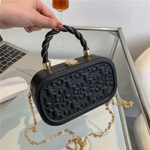 Black embossed box handbag for women, elegant top handle bag with gold chain strap main view.