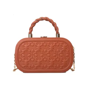 Brown embossed structured box handbag with twisted top handle and gold chain strap retro chic.