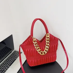 Red pleated handbag for women with chunky gold chain, stylish shoulder and crossbody bag.