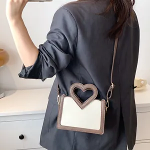 Schicke Damen Umhängetasche mit herzförmigem Griff, modisches kontrastfarbenes Design.