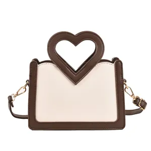 Modische Umhängetasche mit Herzgriff, trendige zweifarbige PU-Leder Handtasche für Damen.