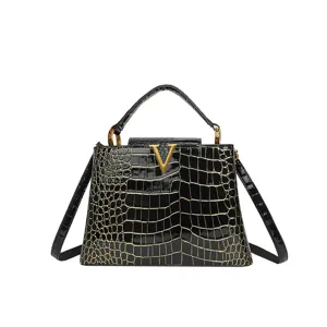Black patent leather crocodile embossed handbag with top handle and metal V logo.