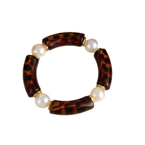 Chic tortoiseshell resin tube and pearl stretch bracelet on a clean white background