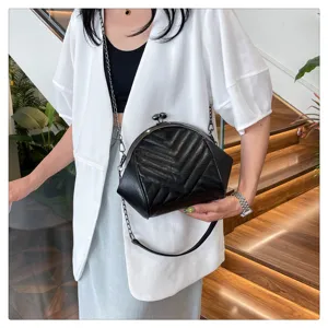 Black quilted chevron kiss-lock shoulder bag, stylish chain crossbody shell handbag for women.