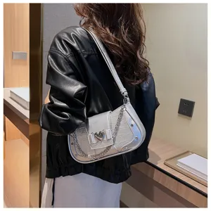 Silver croc-embossed underarm bag detail, stylish metallic chain and heart clasp.