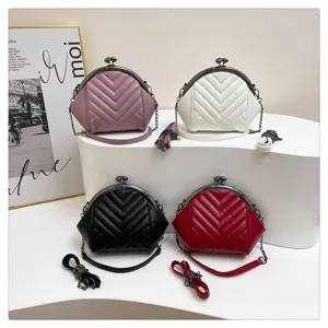 Quilted chevron kiss-lock shoulder bag with metallic chain strap, stylish fashion crossbody purse.