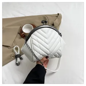 White quilted shell crossbody bag with metal kiss lock and chain strap for women detail.