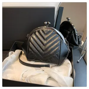 Black quilted chevron kiss-lock shoulder bag with metal chain strap for women chic daily use.