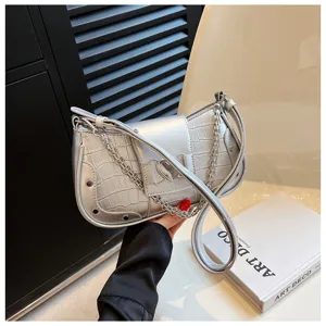 Silver metallic underarm bag with crocodile texture, chic chain strap, and heart buckle.
