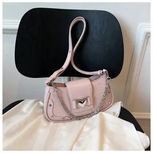 Pink crocodile texture baguette shoulder bag with silver chain and cute heart buckle detail.