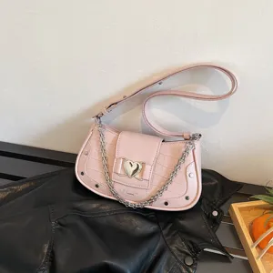 Chic pink croc-embossed shoulder bag with a metal heart buckle and stylish chain strap for women.