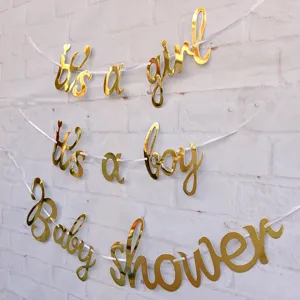 Gold foil letter banner for baby shower and gender reveal party decoration hanging on wall.