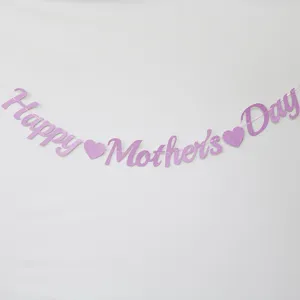 Close-up shot of pink glitter Happy Mother's Day banner detail with cute heart decor.