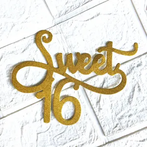 Gold glitter Sweet 16 cake topper detail view, elegant cursive party decoration item.