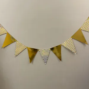 Gold chevron triangular bunting banner for party decoration, hanging garland detail shot.