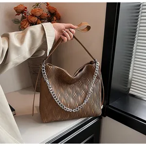 Fashion brown pleated shoulder bag for women, elegant hobo tote with stylish silver chain.