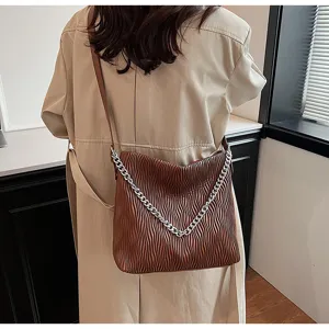 Brown pleated shoulder bag for women, stylish large capacity commuter tote with chain detail.