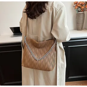 Autumn fashion pleated shoulder bag detail, retro brown leather tote with chunky silver chain.