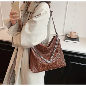 Brown pleated tote shoulder bag detail showing the soft leather texture and metallic chain.