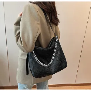 Detail view of the black pleated shoulder tote bag featuring a stylish silver chain and soft leather.