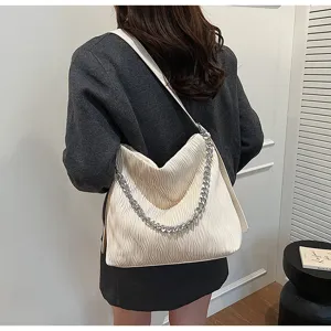 Detailed view of women cream pleated shoulder tote bag with silver chain, chic and spacious.