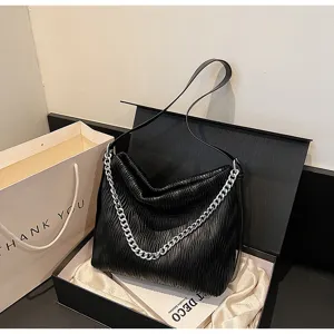 Detail view of the stylish black pleated women shoulder bag with silver chain and large capacity.