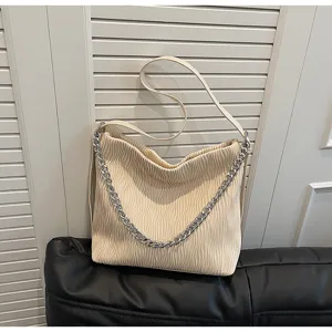 Beige pleated shoulder bag with silver chain detail, casual tote for daily commuting use.