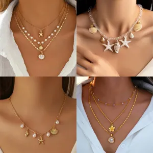 Layered bohemian gold necklace set featuring starfish, shell and pearl charms