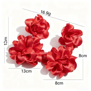 Close-up of oversized red fabric flower earrings with 13cm and 8cm dimensions