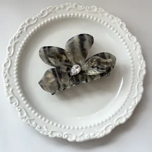 Acetate butterfly hair claw clip for women, elegant floral shark clip for half up hairstyles.