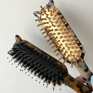 Detailed view of the retro acetate hair brush with cute cat ears, boar bristles and cushion design.
