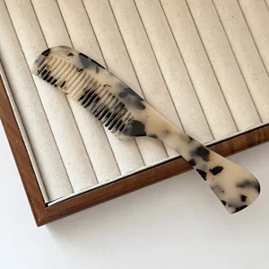 Cellulose acetate hair comb with french tortoiseshell pattern, anti-static round teeth styling.