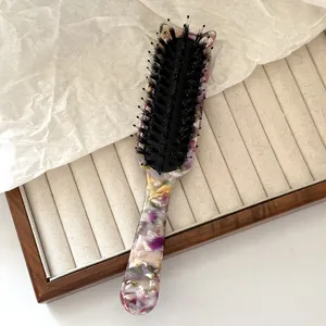 Acetate hairbrush detail featuring floral pattern, boar bristles and cute cat ear top design.