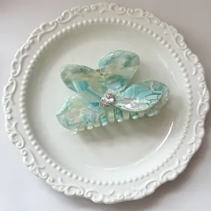 Close-up detail of the elegant blue acetate butterfly hair claw clip with crystal.
