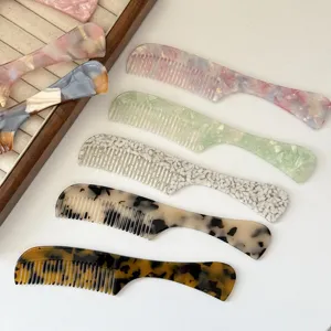 Detailed view of high-quality acetate hair combs with French marble texture and smooth round teeth.