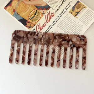 Wide tooth hair comb made of premium acetate sheet with stylish marble pattern design for daily use.