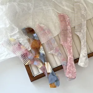 Beautiful acetate hair comb with smooth round teeth, elegant marble texture and portable handle.