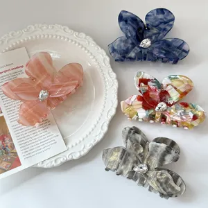 Elegant acetate butterfly hair claw clips with sparkling rhinestones for women summer hair styling.