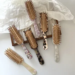 Detail view of vintage acetate hair brush with cute cat ear handle and cushion pins.