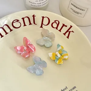 Detailed view of colorful acetate butterfly hair clips, sweet style fringe side clips.