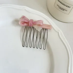 Pink acetate bow hair comb with metal teeth, elegant hair accessory for daily styling.