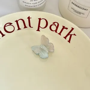 Detailed shot of a gradient acetate butterfly hair claw clip with a transparent pastel finish.