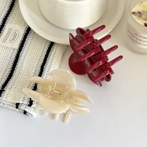 Ein Paar elegante Acryl Haarklammern in Weinrot und Beige, stilvolles Haarzubehör für Damen.