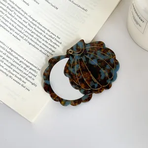 Exquisite shell-shaped portable makeup mirror with chic acetate tortoise shell pattern for daily use.