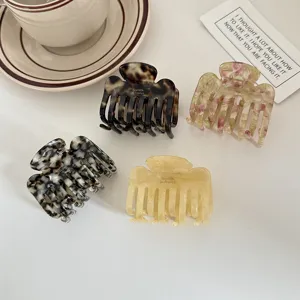 Medium acetate hair claw clip set, elegant tortoiseshell and colorful shark clips for women styling.
