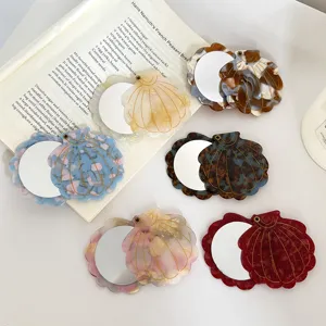 Exquisite shell-shaped portable makeup mirror detail, aesthetic acetate pocket mirror.