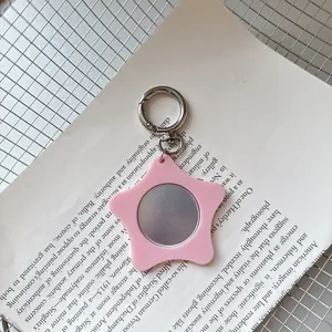 Pink star pocket mirror keychain detail, cute portable makeup mirror and bag pendant accessory.