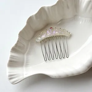 Detailed view of the acetate rhinestone crown hair comb, featuring colorful gems and metal teeth.
