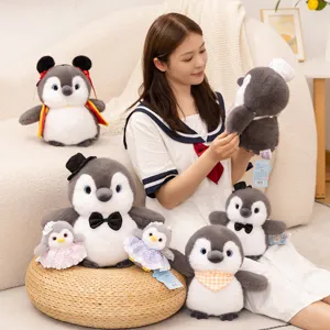 Cute penguin plush toy set with outfits, soft stuffed animal doll desktop decoration.